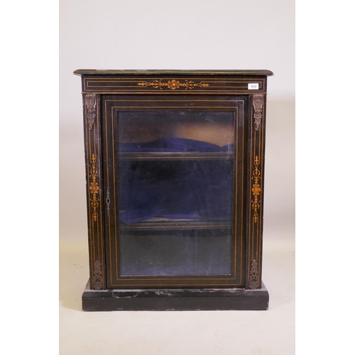 1035 - A Victorian ebonised and inlaid pier cabinet with brass mounts and single glazed door, raised on a p... 