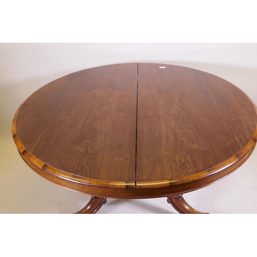 1037 - A Victorian rosewood tilt top breakfast table, raised on turned column tripod supports and carved cl... 