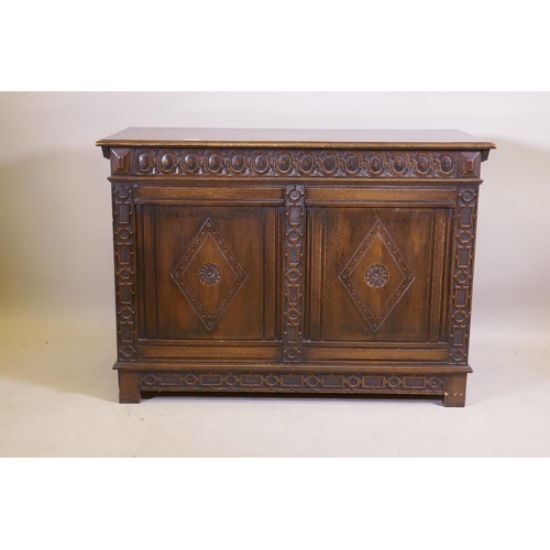 1038 - An oak blanket chest, with lift up top, carved frieze and panelled front and sides, raised on stile ... 