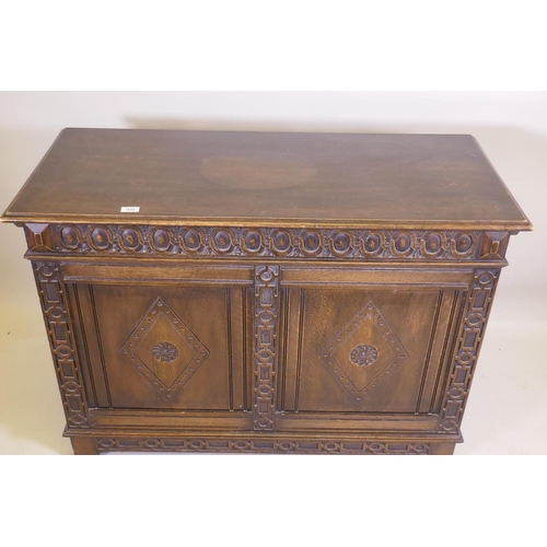 1038 - An oak blanket chest, with lift up top, carved frieze and panelled front and sides, raised on stile ... 