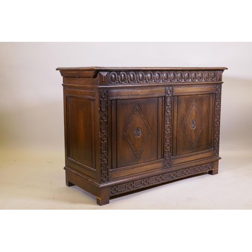 1038 - An oak blanket chest, with lift up top, carved frieze and panelled front and sides, raised on stile ... 