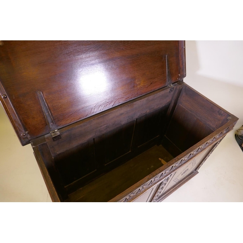 1038 - An oak blanket chest, with lift up top, carved frieze and panelled front and sides, raised on stile ... 