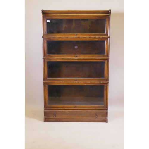 1039 - A Globe Wernicke oak bookcase, with four glazed sections, base section with drawer, and top, 86 x 30... 