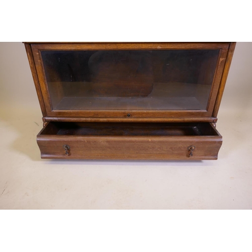 1039 - A Globe Wernicke oak bookcase, with four glazed sections, base section with drawer, and top, 86 x 30... 