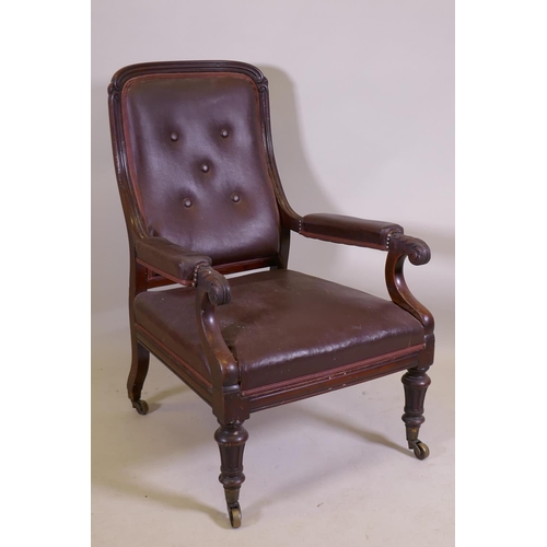 1053 - A C19th mahogany show frame armchair with reeded frame and carved and scrolled arms, raised on turne... 