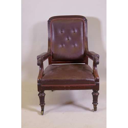 1053 - A C19th mahogany show frame armchair with reeded frame and carved and scrolled arms, raised on turne... 