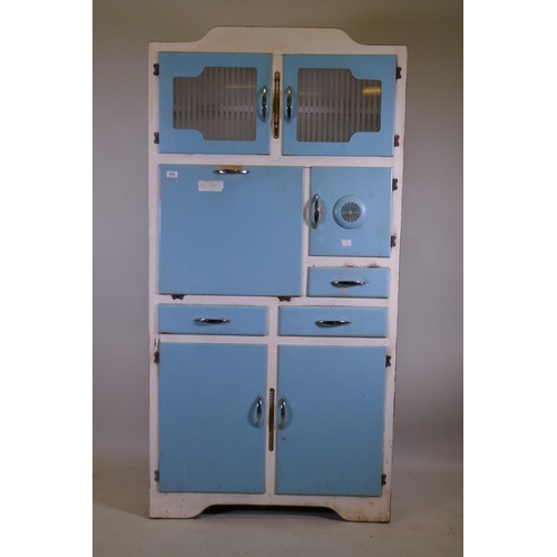 1056 - A mid century Stoneham painted kitchen cabinet with glass doors, fall front, three cupboards and dra... 