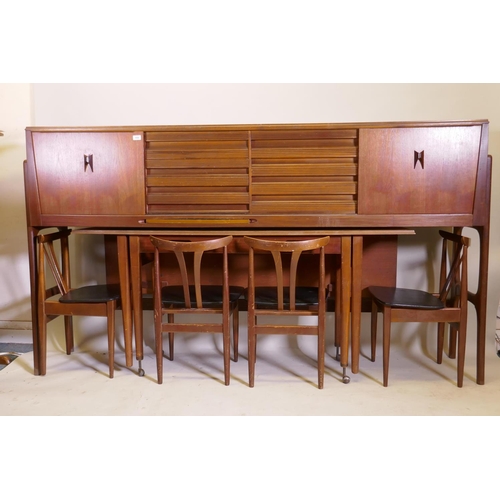 1058 - A mid century Elliott of Newbury teak credenza with sliding doors and three drawers, a pull out fold... 