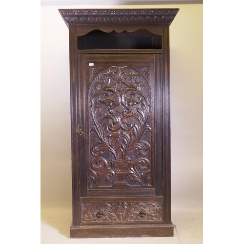 1059 - A C19th oak hall cupboard with single door over a drawer and carved decoration in the Renaissance Re... 