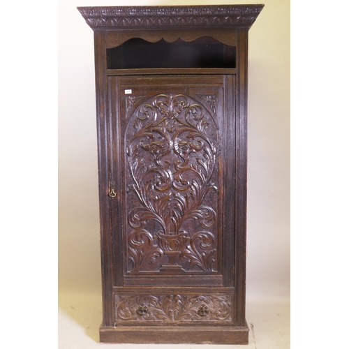 1059 - A C19th oak hall cupboard with single door over a drawer and carved decoration in the Renaissance Re... 