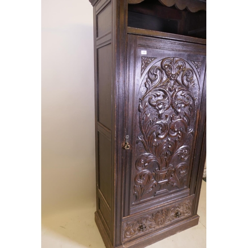 1059 - A C19th oak hall cupboard with single door over a drawer and carved decoration in the Renaissance Re... 