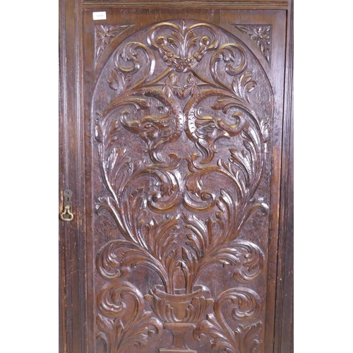 1059 - A C19th oak hall cupboard with single door over a drawer and carved decoration in the Renaissance Re... 