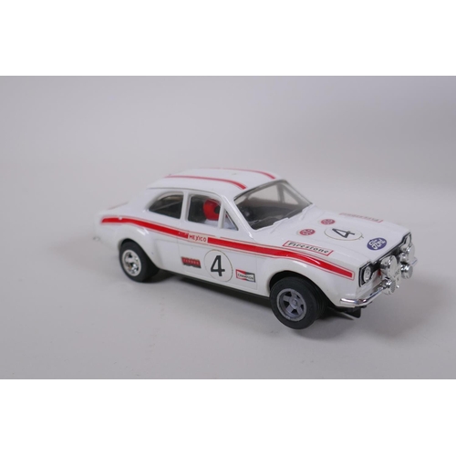 106 - Four 1970s Scalextric cars to include two Mini Cooper C.007 in red and yellow, a Datsun 260Z C.053 a... 