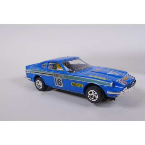 106 - Four 1970s Scalextric cars to include two Mini Cooper C.007 in red and yellow, a Datsun 260Z C.053 a... 