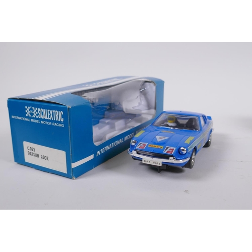 106 - Four 1970s Scalextric cars to include two Mini Cooper C.007 in red and yellow, a Datsun 260Z C.053 a... 