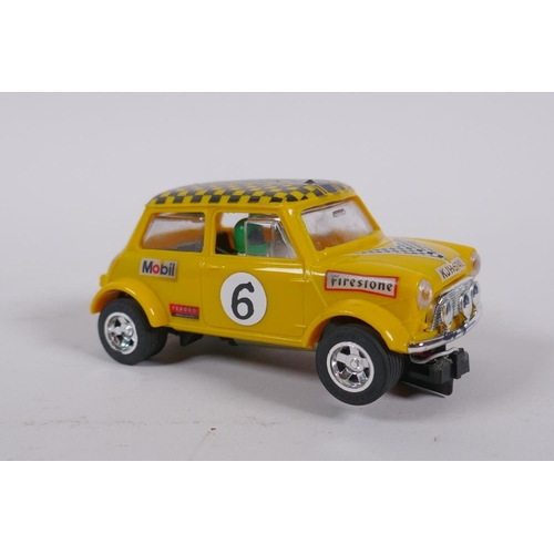 106 - Four 1970s Scalextric cars to include two Mini Cooper C.007 in red and yellow, a Datsun 260Z C.053 a... 