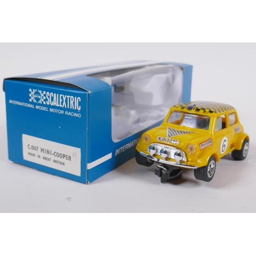 106 - Four 1970s Scalextric cars to include two Mini Cooper C.007 in red and yellow, a Datsun 260Z C.053 a... 