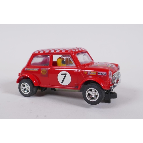 106 - Four 1970s Scalextric cars to include two Mini Cooper C.007 in red and yellow, a Datsun 260Z C.053 a... 