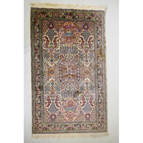 1063 - An ivory ground silk Turkmen rug with multicolour floral design, 94 x 154cm