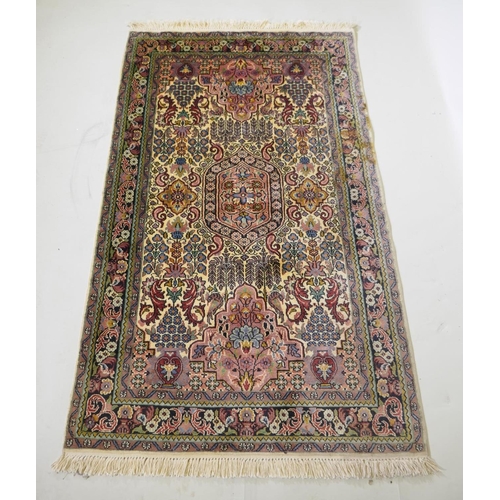 1063 - An ivory ground silk Turkmen rug with multicolour floral design, 94 x 154cm