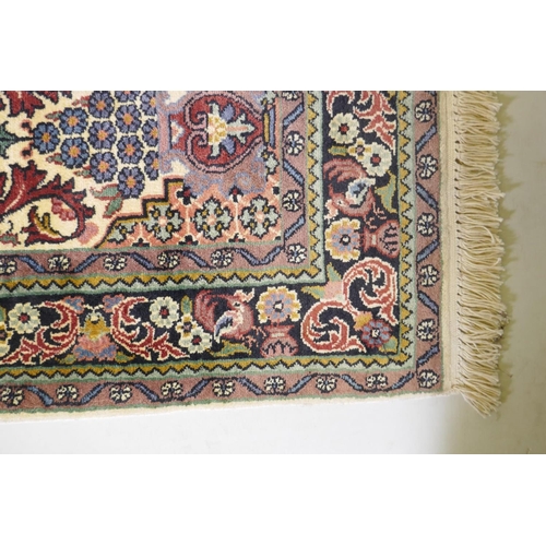 1063 - An ivory ground silk Turkmen rug with multicolour floral design, 94 x 154cm