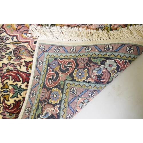 1063 - An ivory ground silk Turkmen rug with multicolour floral design, 94 x 154cm