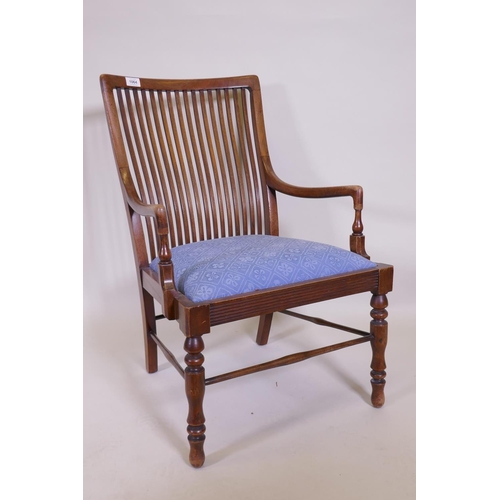 1064 - A Liberty & Co, Arts and Crafts  walnut bedroom chair with slat back and reeded frieze, raised o... 