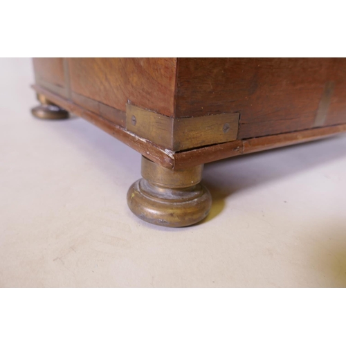 1070 - A C19th teak Anglo Indian vanity chest with campaign style brass mounts and handles, raided on brass... 