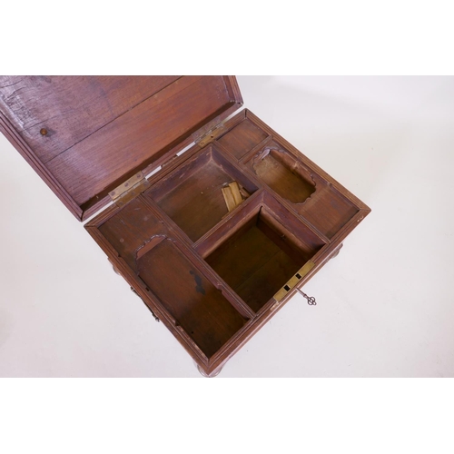 1070 - A C19th teak Anglo Indian vanity chest with campaign style brass mounts and handles, raided on brass... 