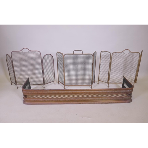 1072 - An antique pierced brass fire fender and three folding spark guards, fender 127 x 34cm, 18cm high