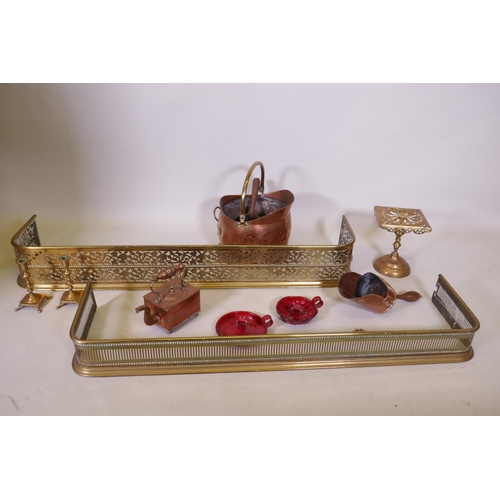 1079 - An antique pierced brass fire fender and another smaller, together with a collection of copper, bras... 