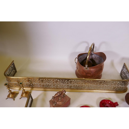 1079 - An antique pierced brass fire fender and another smaller, together with a collection of copper, bras... 