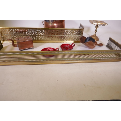 1079 - An antique pierced brass fire fender and another smaller, together with a collection of copper, bras... 