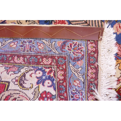 1080 - An Iranian cream ground wool rug with blue and red panelled design, 112 x 156cm