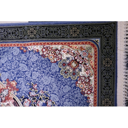 1081 - An Iranian fine woven blue ground runner with a medallion design surrounded by an embossed all over ... 