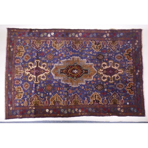 1083 - A hand woven blue ground wool Persian Belouch nomadic rug, 190 x 120cm