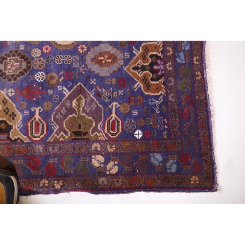 1083 - A hand woven blue ground wool Persian Belouch nomadic rug, 190 x 120cm