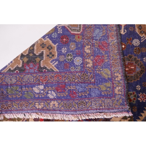 1083 - A hand woven blue ground wool Persian Belouch nomadic rug, 190 x 120cm