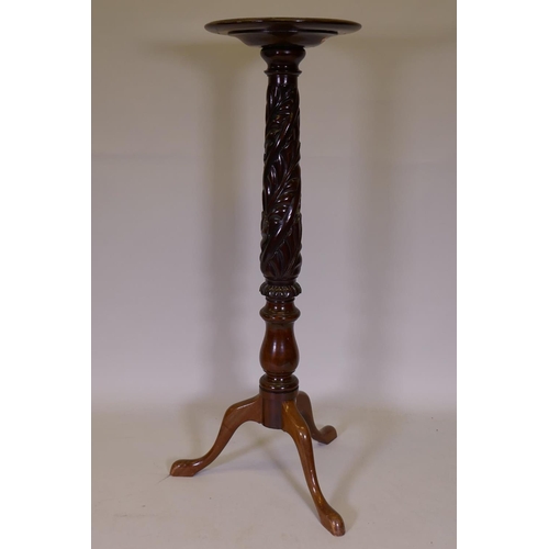 1084 - A mahogany torchere, raised on a carved column and tripod supports, 126cm high, 39cm diameter