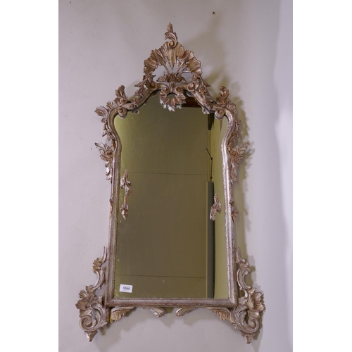 1085 - A Venetian carved wood wall mirror with silver leaf decoration, AF losses