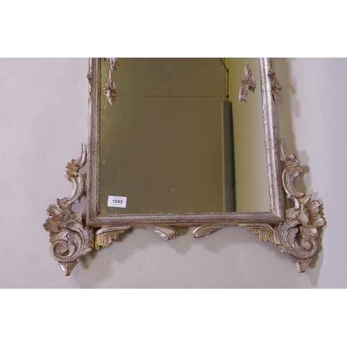 1085 - A Venetian carved wood wall mirror with silver leaf decoration, AF losses