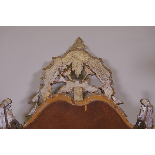 1085 - A Venetian carved wood wall mirror with silver leaf decoration, AF losses