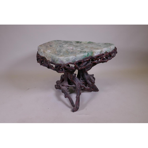 1090 - An oriental green quartz/fluorspar top table, raised on a rootwood base, AF, 80 x 65 x 56cm