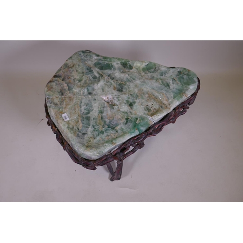 1090 - An oriental green quartz/fluorspar top table, raised on a rootwood base, AF, 80 x 65 x 56cm