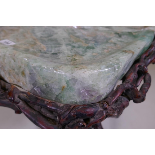 1090 - An oriental green quartz/fluorspar top table, raised on a rootwood base, AF, 80 x 65 x 56cm