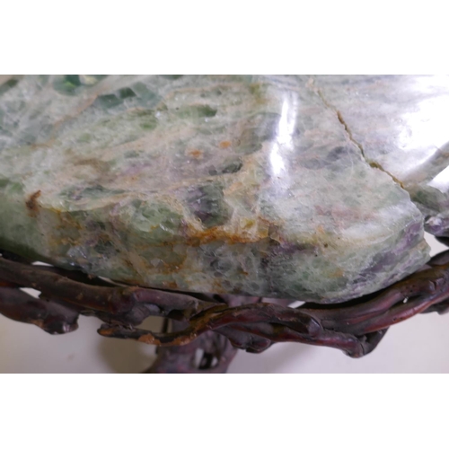 1090 - An oriental green quartz/fluorspar top table, raised on a rootwood base, AF, 80 x 65 x 56cm