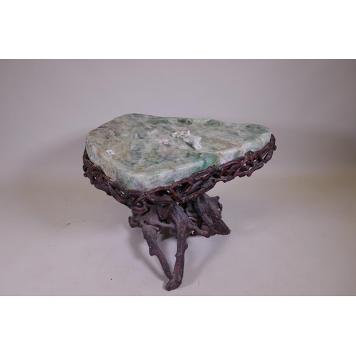 1090 - An oriental green quartz/fluorspar top table, raised on a rootwood base, AF, 80 x 65 x 56cm