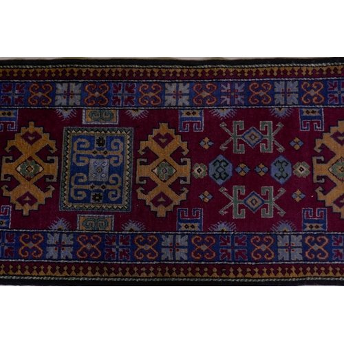 1092 - A claret wine ground wool caucasian runner with bespoke medallion design in unique colours, 322 x 73... 