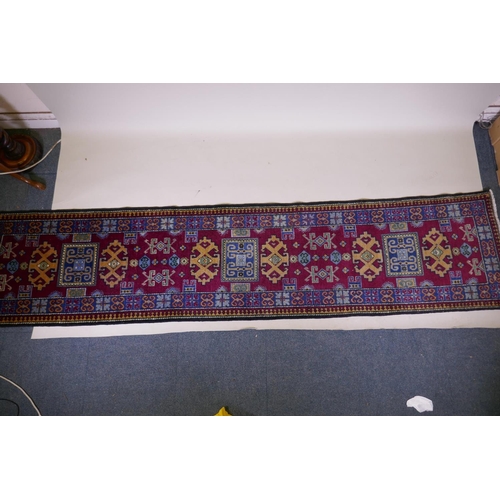 1092 - A claret wine ground wool caucasian runner with bespoke medallion design in unique colours, 322 x 73... 