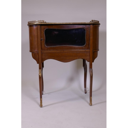 1093 - An inlaid mahogany kidney shaped vitrine, with pierced brass gallery top, single glazed door, raised... 